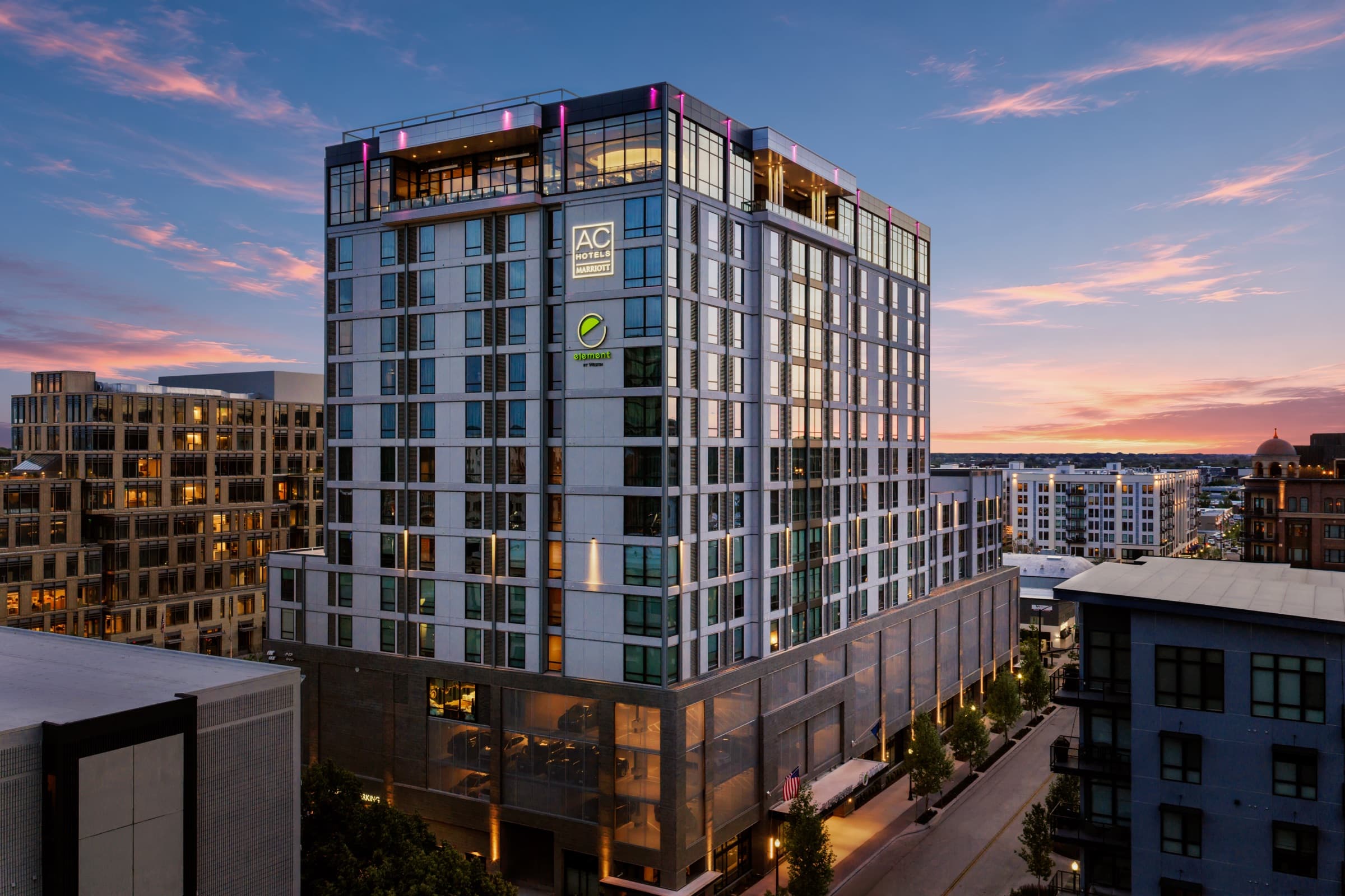 AC Hotel Boise Downtown at dusk, rooftop terrace lit