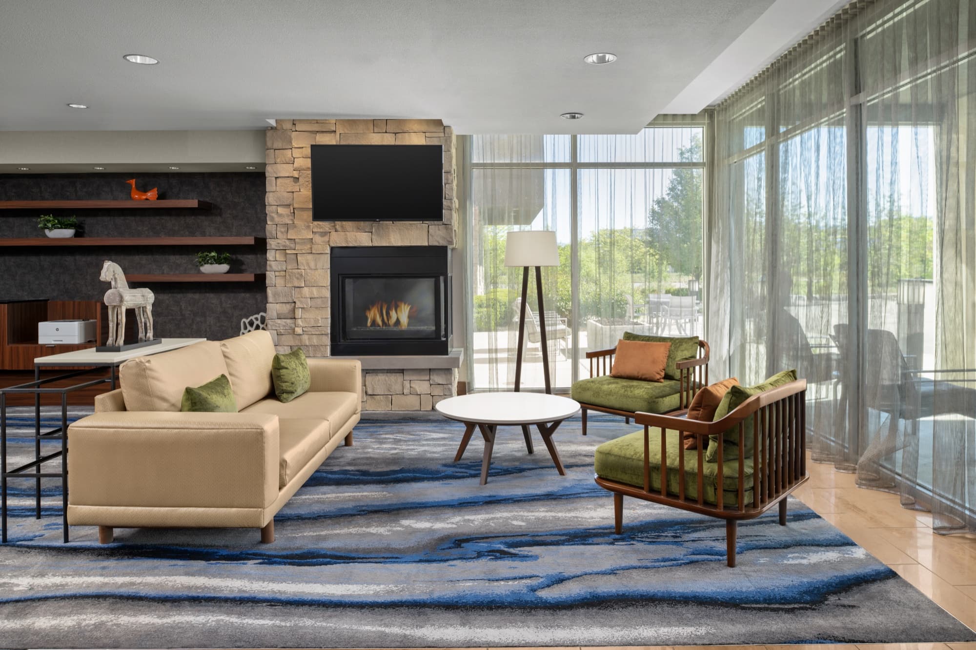 Hotel lobby with layered evening lighting — seating, front desk, and market in one frame