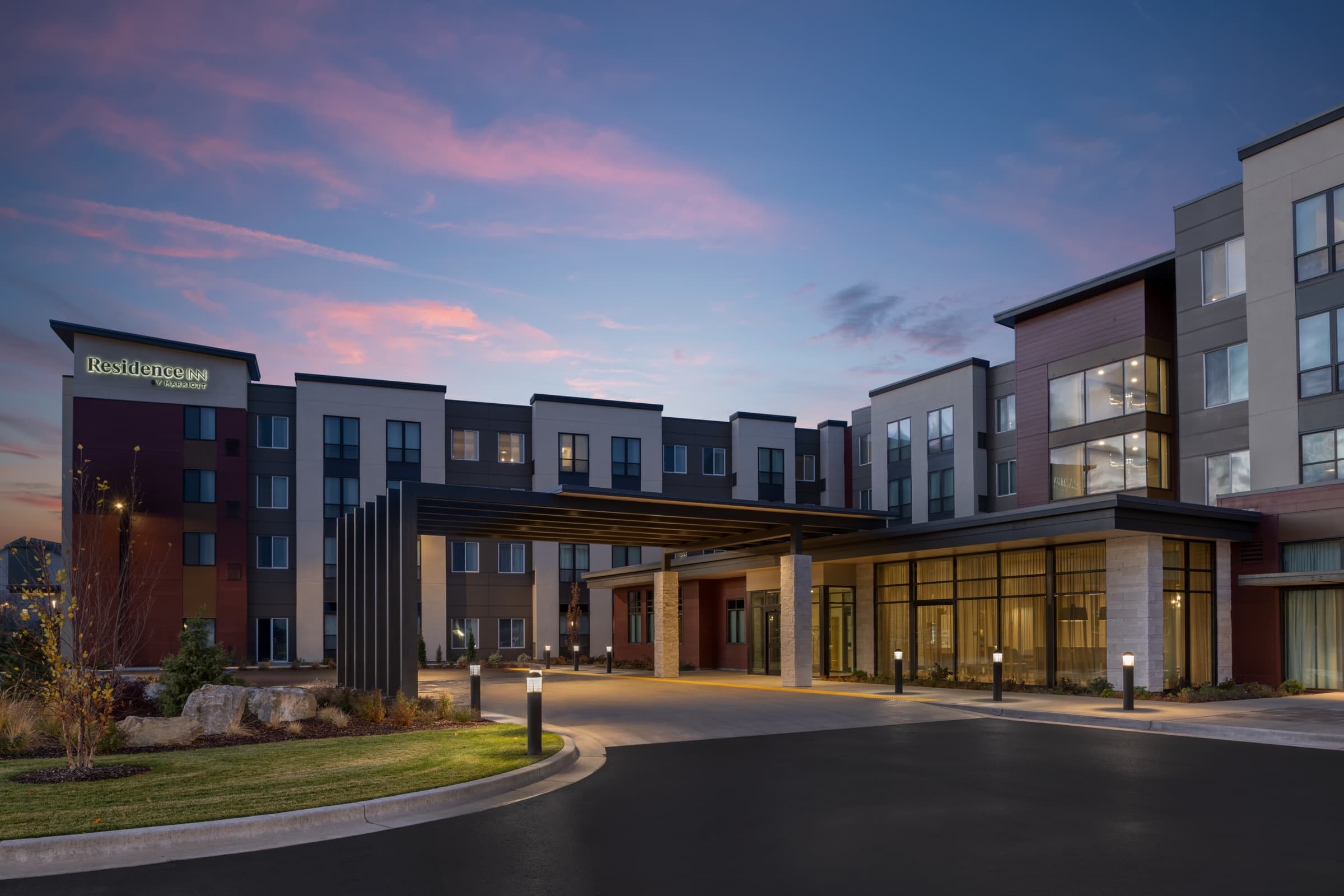 Residence Inn by Marriott exterior at twilight, windows glowing against a real dusk sky