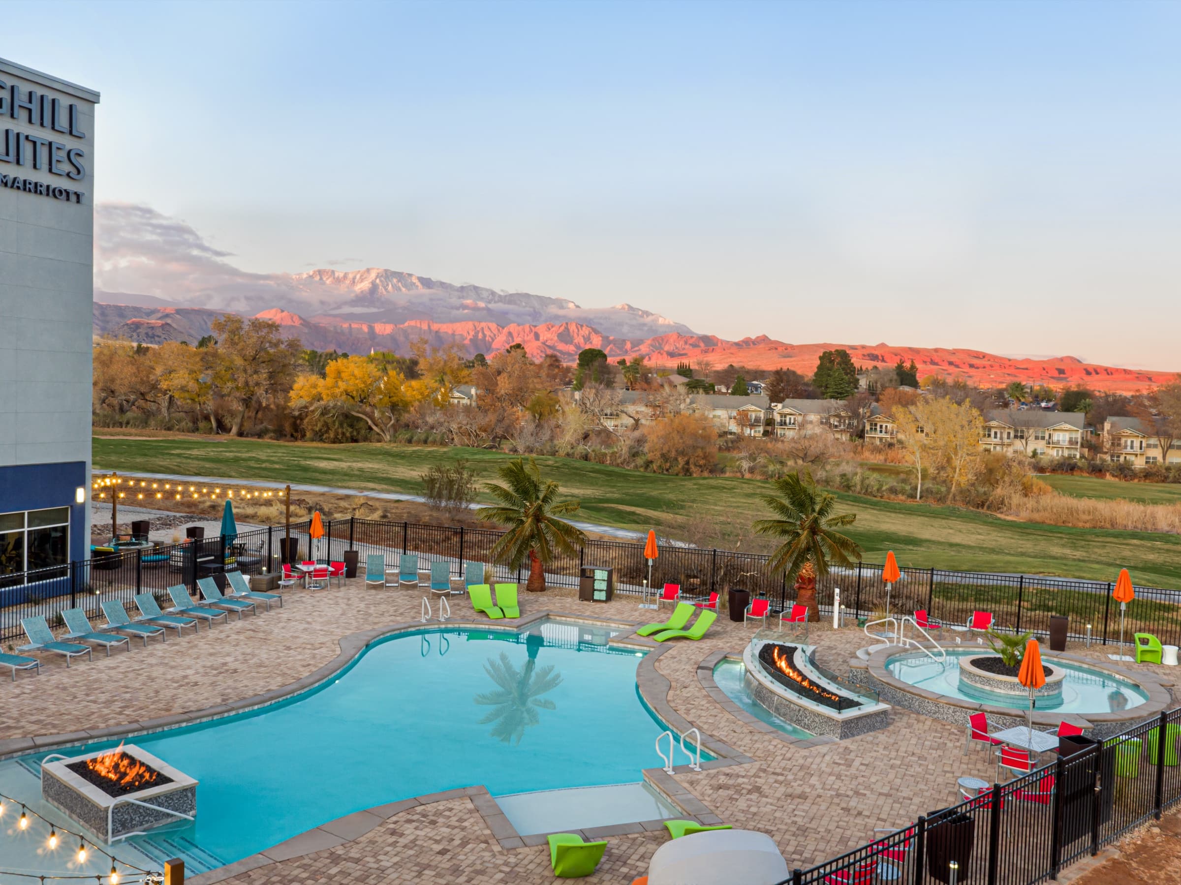Resort pool deck and cabanas from the air at dusk